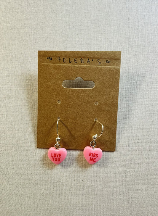Helena’s Artisan & Gift Co. pink resin candy heart dangle earrings with Love You and Kiss Me messages on display card